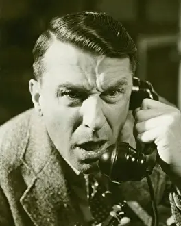 Wavy Hair Prints: Distressed man on landline phone, (B&W), close-up