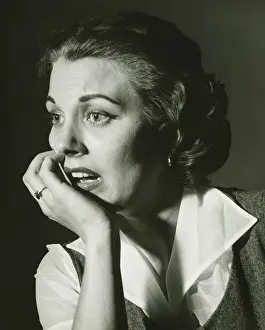 Hand On Chin Prints: Distressed woman posing in studio, (B&W), portrait