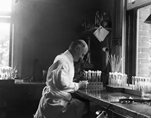 Researcher Prints: Doctor Looking Through Microscope