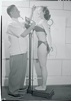 Doctor Measuring Woman's Height