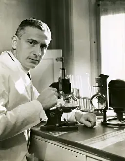 Doctor with microscope in lab