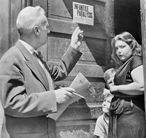 Doctor Placing Quarantine Sign on Family