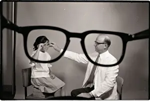 Doctor Puts Glasses on Girl