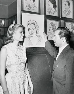 Don Bevan Showing Caricature of Grace Kelly