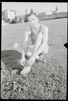 Don Bowden Sitting on Ground and Adjusting His Shoes