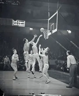 Don Henderson and Jack Harvey Vying for Basketball
