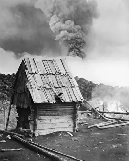 Prints of circa 1950: The lava from Mount Par cutin, El Monstre, flowing into the village of San Juan, soon to destroy everything except the church, which still stands half buried in solidified lava Three Lions Photo Agency Prints: Doomed Lava Hut