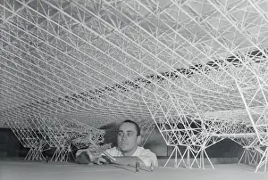 Douglas Rhyn Holding Model Airplane Under Model of Proposed Hanger