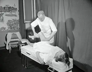 Dr. Exercising Woman's Leg