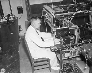 Dr. Harold C. Urey at Spectrometer