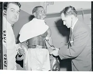 Dr. Harold Kleinman Measuring Isaac Logart's Blood Pressure