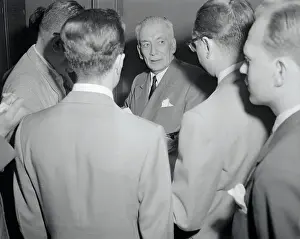 Dr. Laureano Gomez Standing with Group of Men
