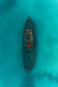 Images Dated 3rd August 2019: Drone shot directly above a red kayak floating above a shipwreck, Carlisle Bay, Barbados