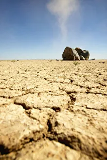 Namibia Collection: Dry Cracked Soil in Foreground with Boulders in Background