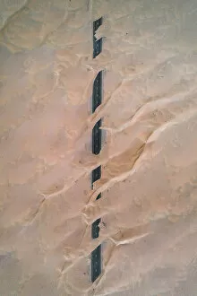 Amazing Deserts Gallery: Dunes crossing a straight road in the desert, Dubai, United Arab Emirates