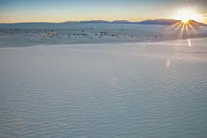 Lens Flare Prints: Dunes at White Sands National Monument with San Andres Mountains on horizon at sunset