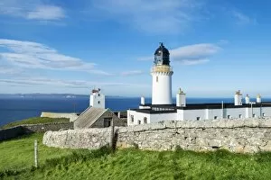 Dunnet Head lighthouse on the north coast of Scotland, Orkney Islands at back on the horizon, Caithness, Scotland