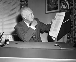Dwight D. Eisenhower Holding Bill at His Desk