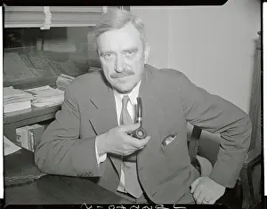 Earl Browder Posing with Pipe in Hand