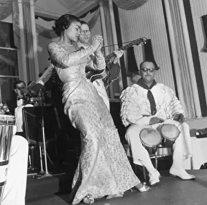 Prints of 3rd February 1951: Nightclub singer Eartha Kitt, who was discovered by Orson Welles, is accompanied by a man in a frilly shirt on the bongos at the Churchill Club Captivating Art Prints Celebrating the Iconic Performer’s Legacy: Early Eartha