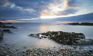 Images Dated 12th July 2016: Early morning landscape of ocean over rocky shore with glowing sunrise - Findochty, Scotland