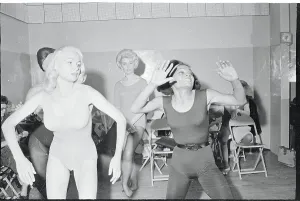 Prints of (Original Caption). Bending over with enthusiasm shapely Les Femmes look toward Eartha Kitt (left) for further instructions during a dance lesson Captivating Art Prints Celebrating the Iconic Performer’s Legacy: Eartha Kitt Giving Dance Lessons