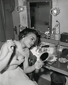 Prints of (Original Caption). Singer Eartha Kitt, a sensation in New Faces of 1952, checks here make-up as her cat Jinx looks on with wide eyes Captivating Art Prints Celebrating the Iconic Performer’s Legacy: Eartha Kitt with Jinx