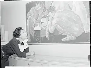 Prints of (Original Caption). Internationally-known singer Eartha Kitt, now appearing in a Chicago Musical, muses over the importance of being Erni at a showing of the Swiss artist's works Captivating Art Prints Celebrating the Iconic Performer’s Legacy: Eartha Kitt Studying a Painting