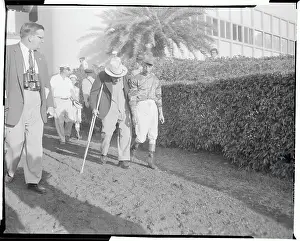 Eddie Arcaro and Sunny Jim Fitzsimmons Walking at Racetrack