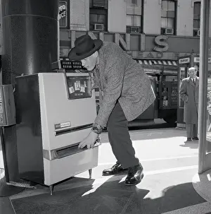 Eddie Carmel Using a Cigarette Machine