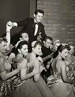 Eddie Fisher on Shoulders of Cast Members