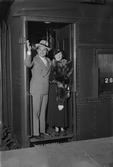 Edward G Prints: Edward Robinson Waving from Doorway with His Wife