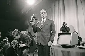 Edwin H Prints: Edwin Land Holding Movie Camera