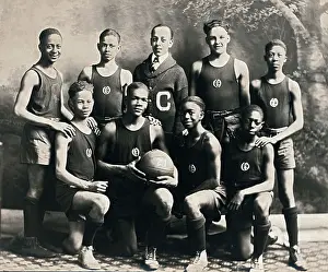 Prints of The African American basketball team at Oliver High School and their coach, EJ Hooper, lined up for a portrait, Winchester, Kentucky, circa 1921. (Photo by Underwood Archives/Getty Images) Courtside Vibes: Stunning Basketball Prints: EJ Hooper Basketball Team