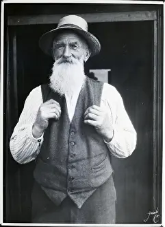 Elderly Bearded Man Wearing Straw Hat and Vest
