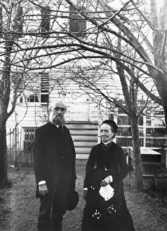 Couples Prints: Elderly Couple Stand In Front Of Home