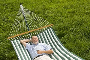 Satisfaction Gallery: Elderly gentleman lying in a hammock and listening to music