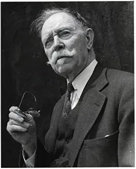 Elderly Man Shown Holding Glasses