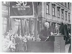 Elderly Man Speaking Outside at Podium