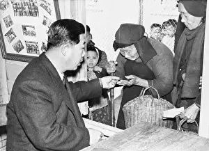 Elderly Woman At Counter Receiving Money