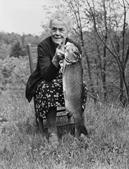 Elderly Woman Holding Fish She Caught