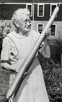 String Prints: Elderly Woman Holding Gigantic Bean