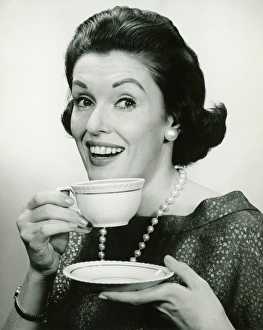 Pearl Collection: Elegant holding cup and saucer, (B&W), (Portrait)