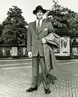 40 49 Years Prints: Elegant man carrying overcoat courtyard, (B&W)