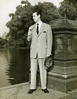 Edge Prints: Elegant man smoking pipe by park lake, (B&W), portrait