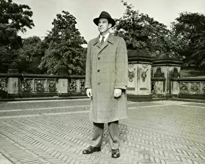 Elegant man standing on courtyard, (B&W), (Portrait)