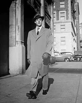 Glove Prints: Elegant man walking alone along city street, (B&W)