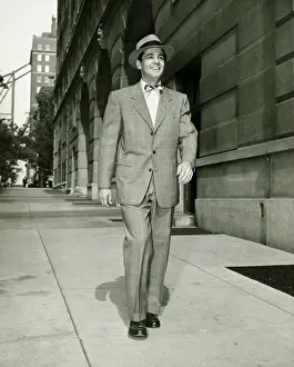 Sidewalk Prints: Elegant man walking on sidewalk, (B&W)