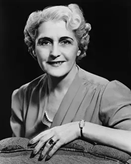Elegant mature woman smiling, (B&W), portrait