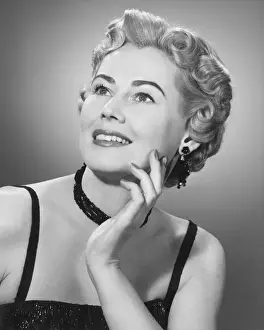 Elegant woman posing in studio, (B&W), portrait